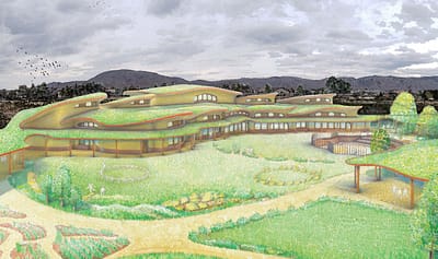 View of the Waldorf school from the southwest side. Organically shaped roofs correspond to the character of the surrounding landscape. In the middle we see the upper part, where there is a gym and a school hall. The lowered roof in the foreground, where the entrance to the school is, protects the south windows from summer overheating.